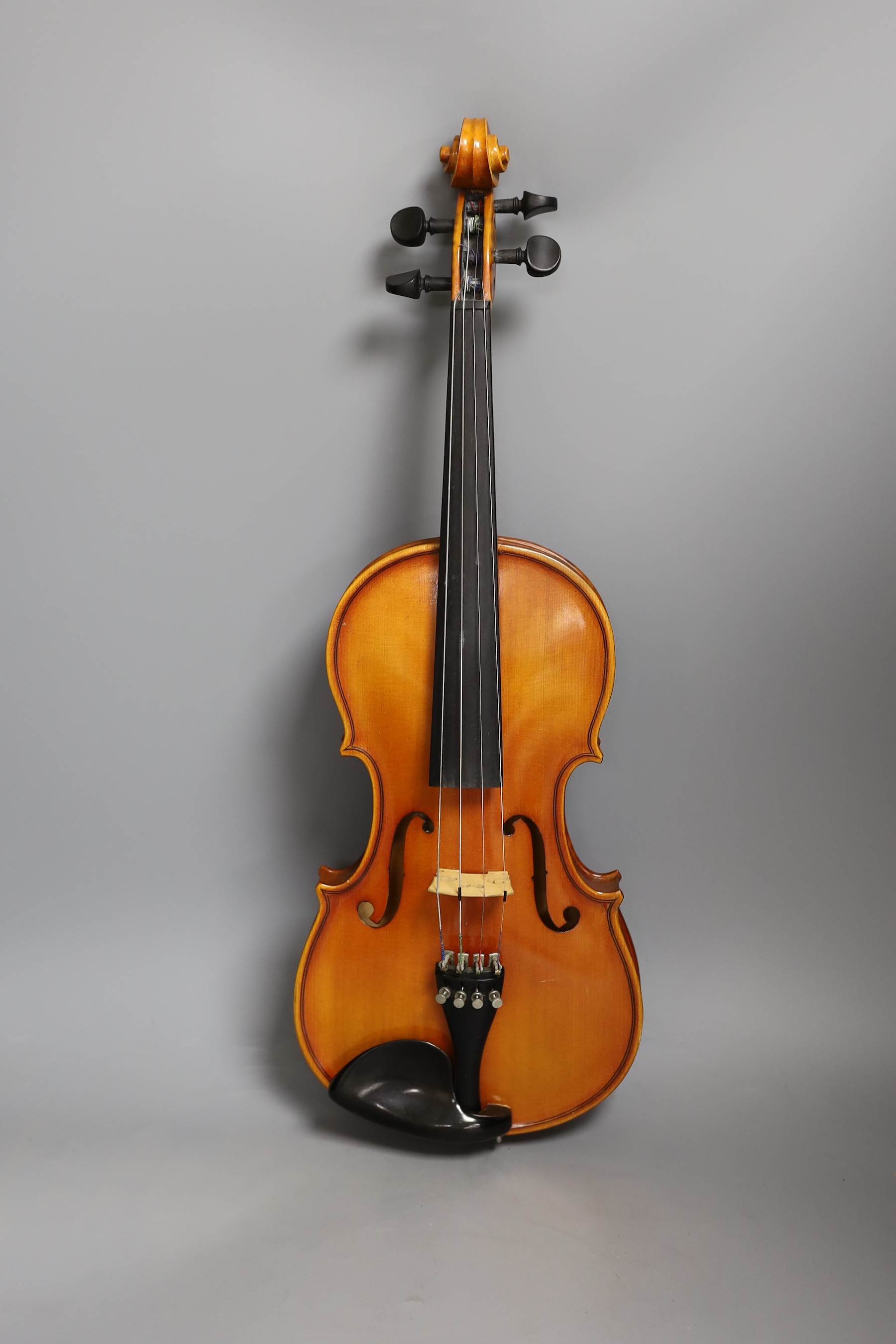 A cased child's violin and bow with ivorine tip, violin 55cms long